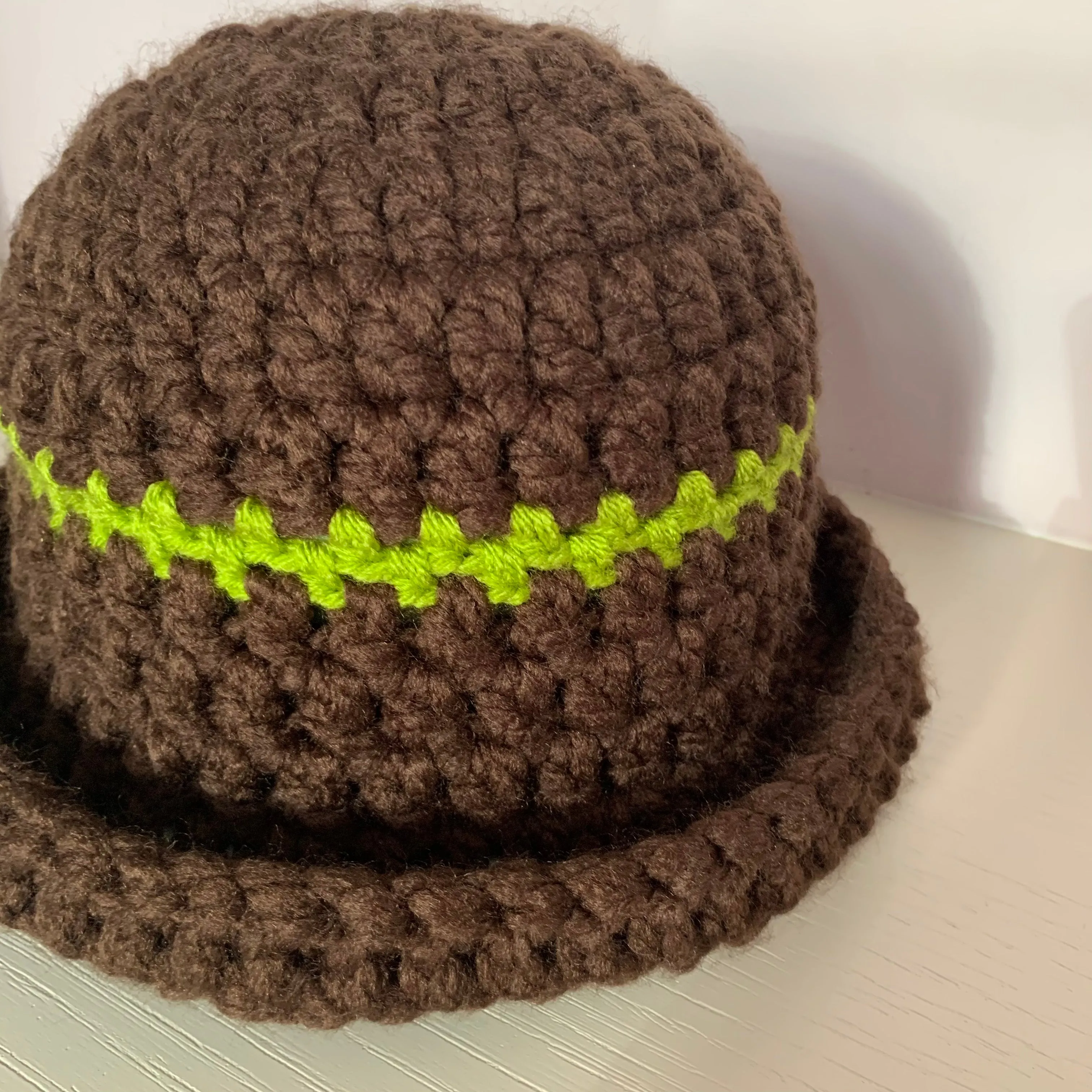 Handmade brown chunky crochet bowler hat with olive green stripe