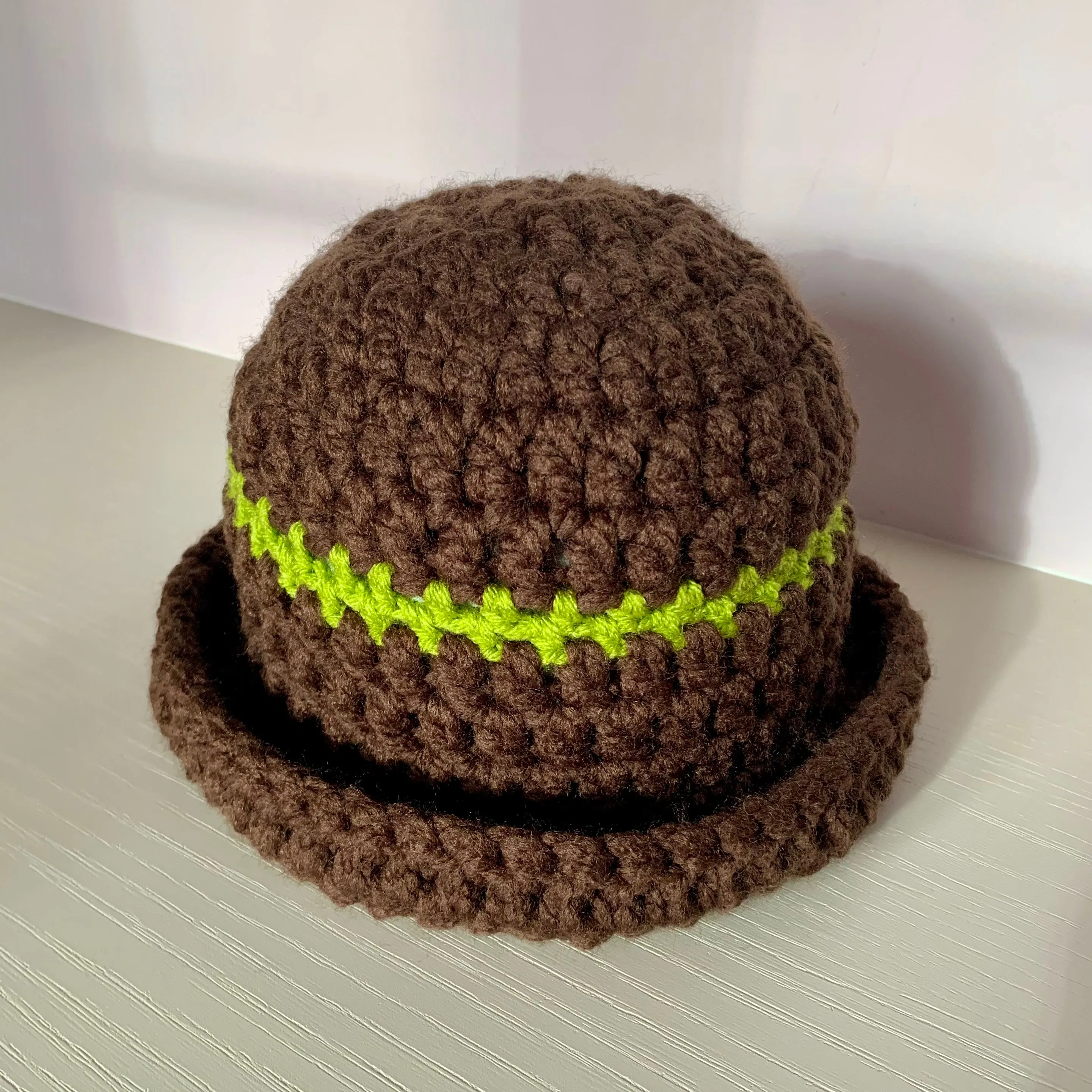 Handmade brown chunky crochet bowler hat with olive green stripe