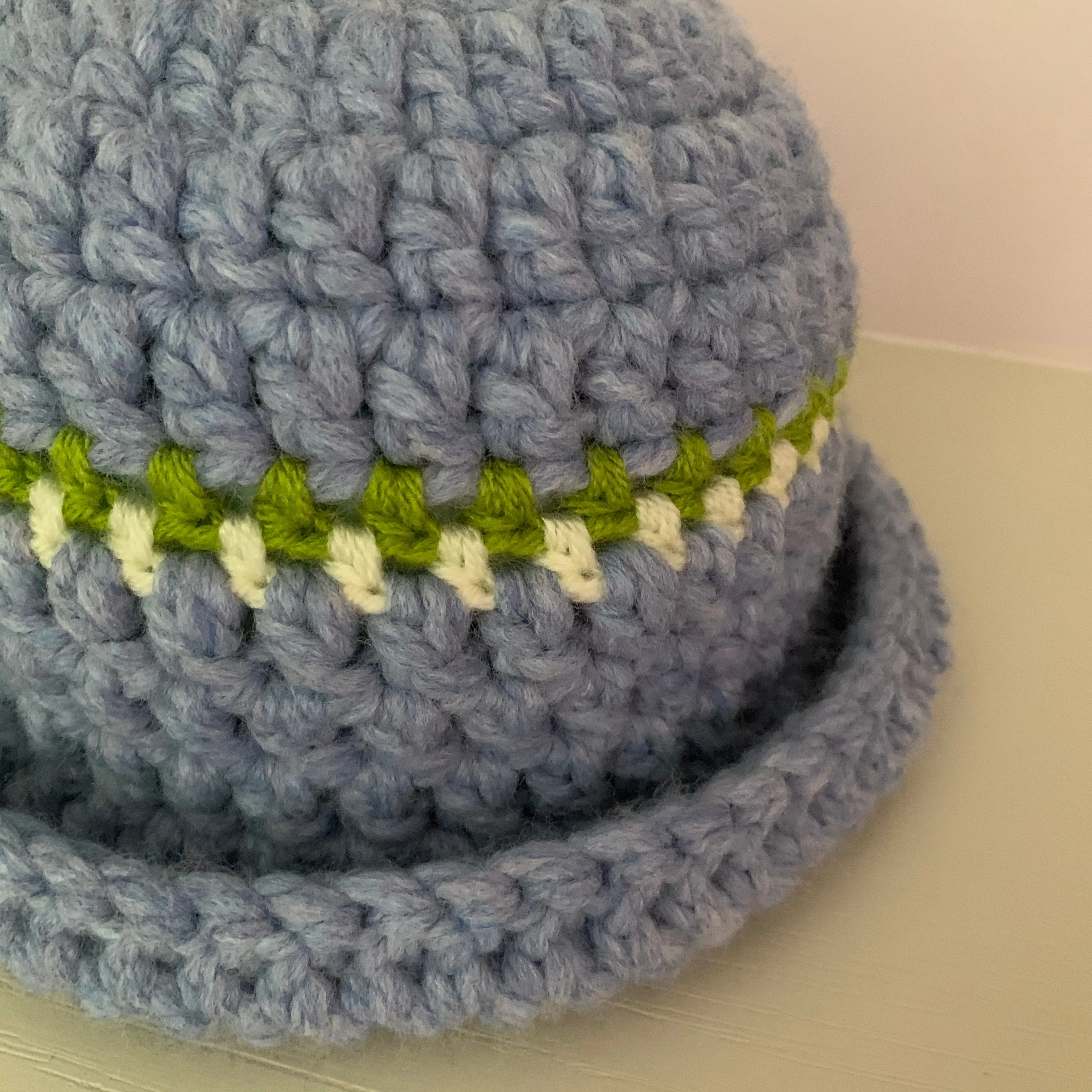 Handmade cornflower blue chunky crochet bowler hat with olive green and cream stripes