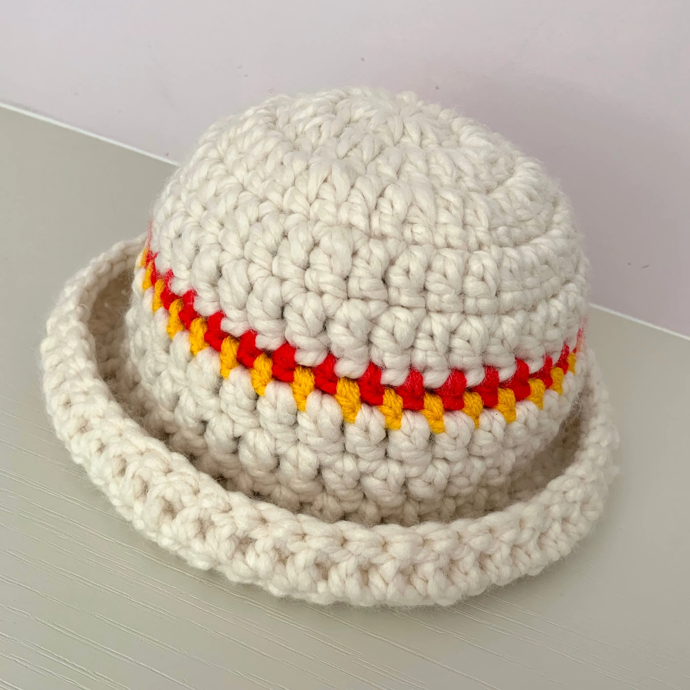 Handmade cream chunky bowler hat with red and yellow stripes