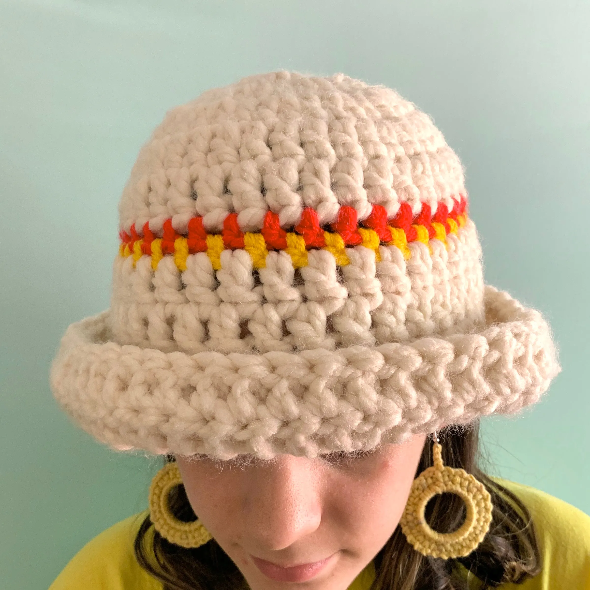 Handmade cream chunky bowler hat with red and yellow stripes