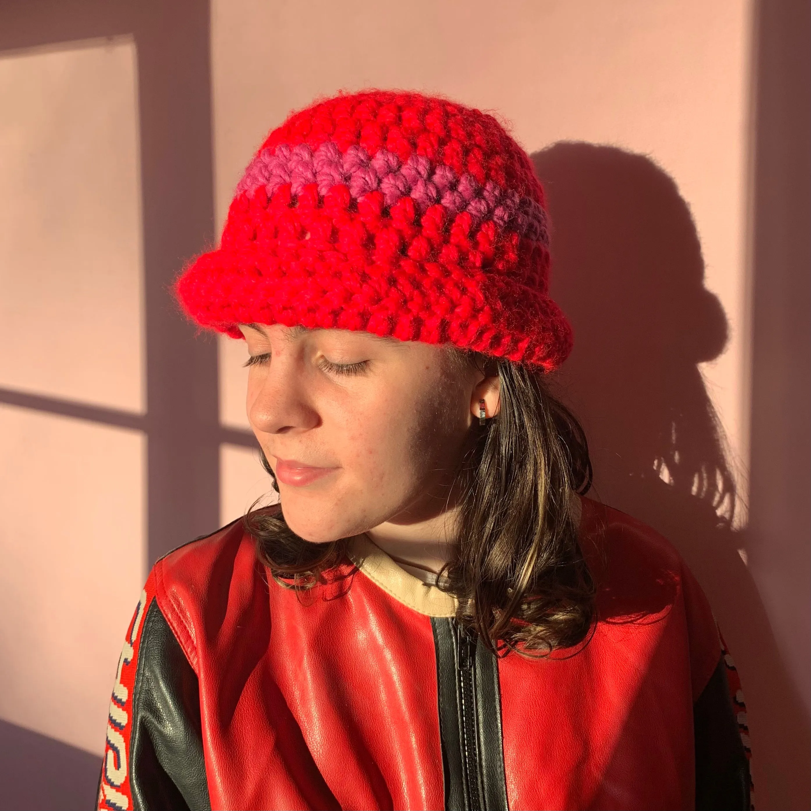 Handmade scarlet red chunky crochet bowler hat with fuschia pink stripe